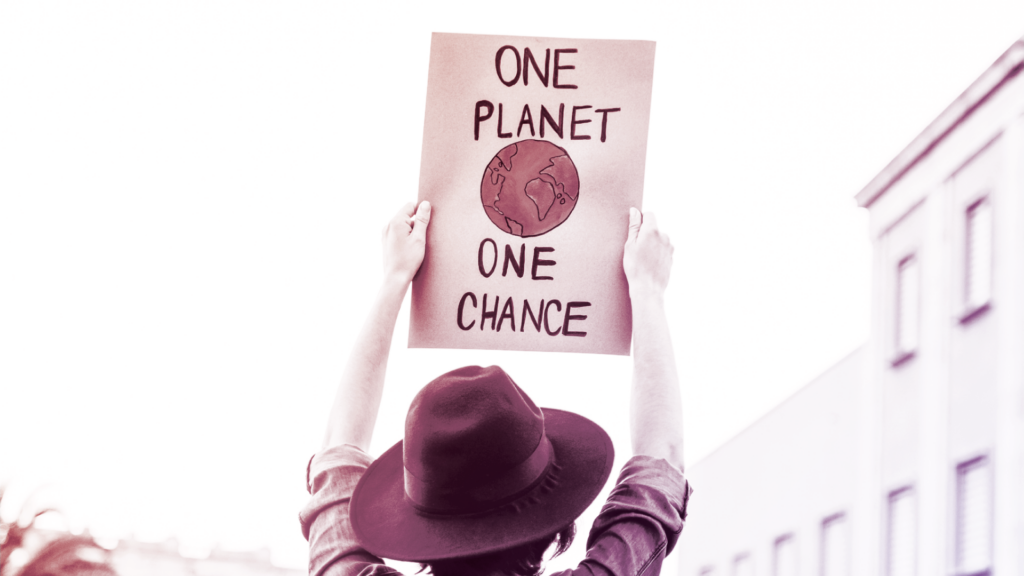 Demonstrator holding sign that says "One planet One Chance"
